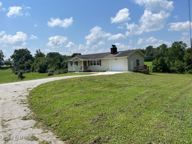 single story home with a garage and a front lawn