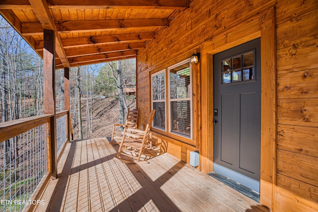 wooden terrace featuring covered porch