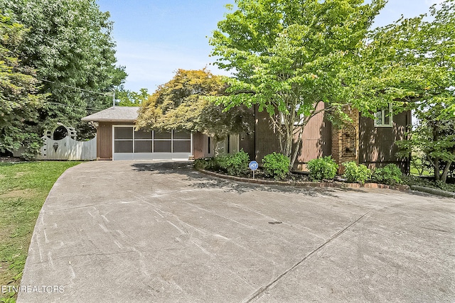 obstructed view of property with a garage