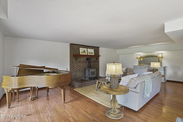 living room with hardwood / wood-style flooring and a wood stove