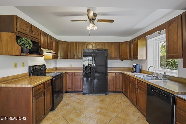 kitchen featuring sink, light tile patterned floors, black appliances, and ceiling fan