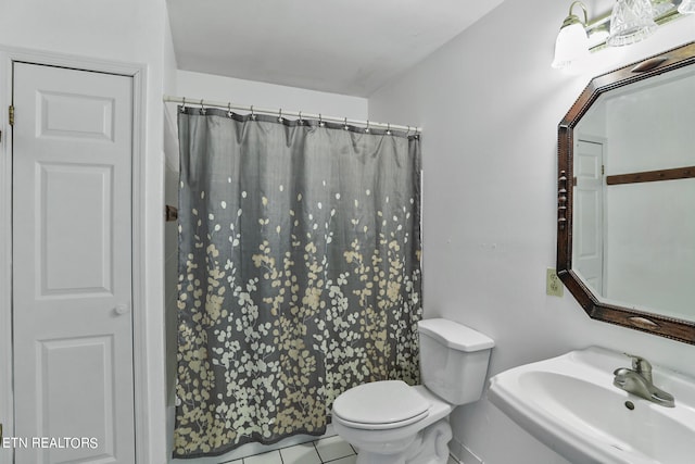 bathroom featuring tile patterned floors, sink, walk in shower, and toilet