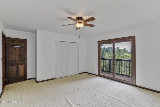 unfurnished bedroom featuring light carpet, access to outside, a closet, and ceiling fan