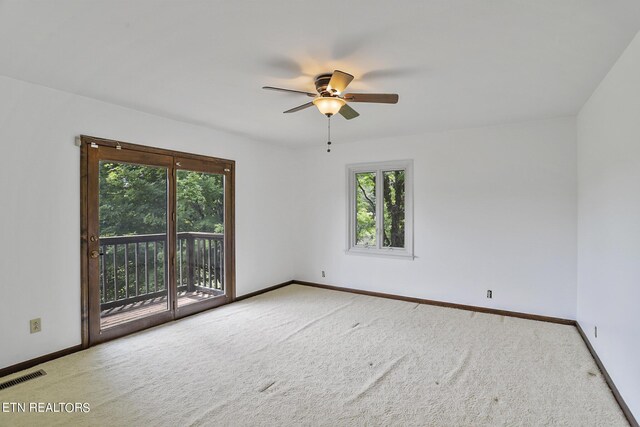 unfurnished room with carpet flooring, a wealth of natural light, and ceiling fan