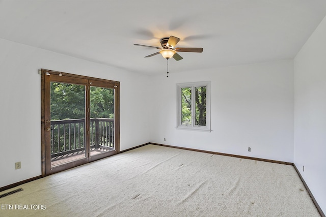 spare room featuring carpet flooring and ceiling fan