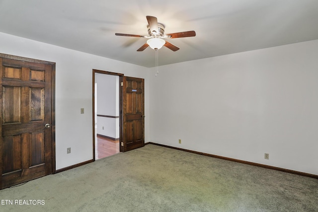 unfurnished bedroom featuring ceiling fan and light colored carpet