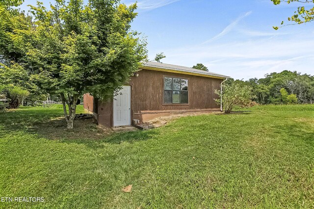 view of side of property with a yard