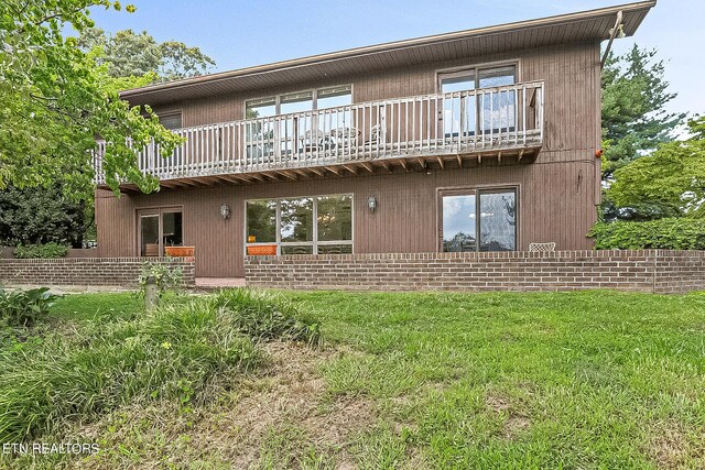 rear view of property with a balcony