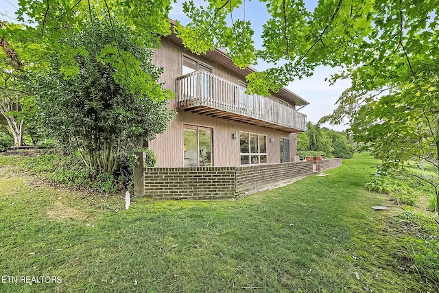 view of side of property with a yard