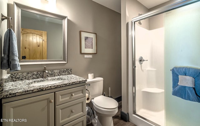 bathroom with vanity, walk in shower, wood-type flooring, and toilet