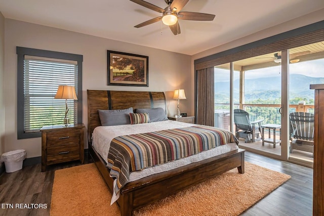 bedroom featuring access to exterior, multiple windows, ceiling fan, and dark hardwood / wood-style flooring