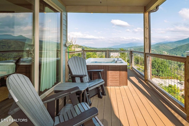 wooden terrace with a mountain view and a hot tub