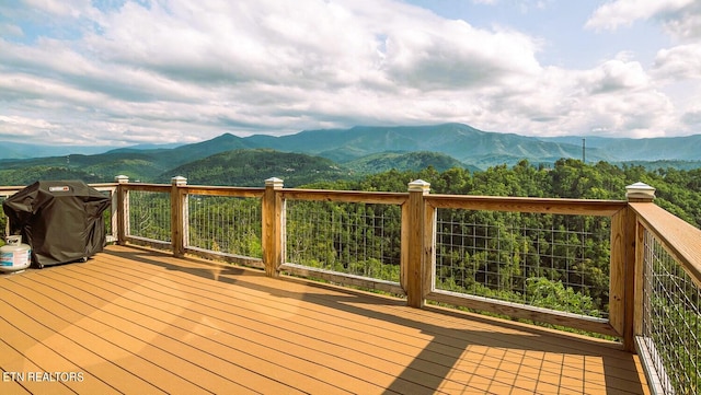 deck with a mountain view and area for grilling