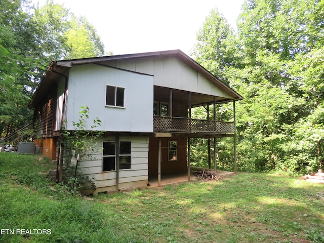 back of house featuring a sunroom and a yard