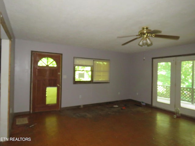 foyer entrance with ceiling fan and dark wood-style flooring