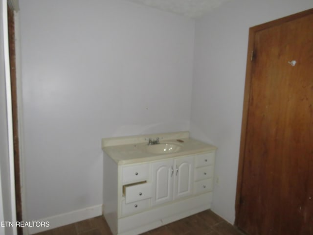 bathroom featuring vanity and baseboards