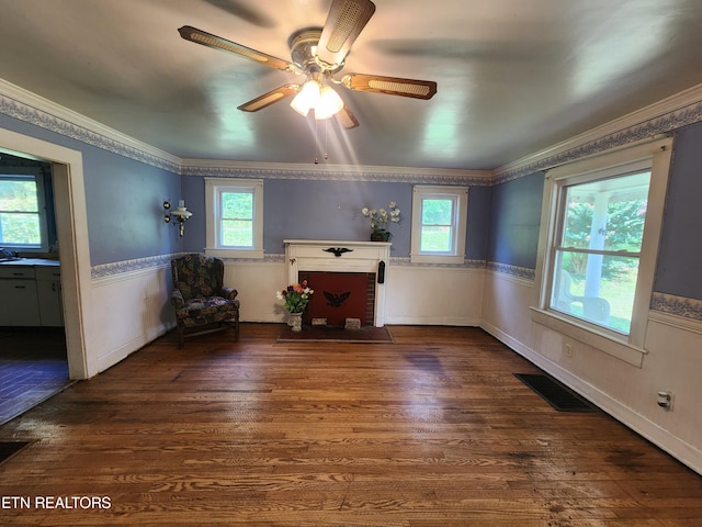 unfurnished room with crown molding, a wealth of natural light, and dark hardwood / wood-style floors