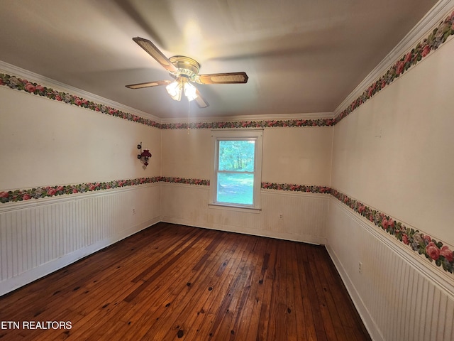 empty room with dark wood-type flooring, ornamental molding, and ceiling fan