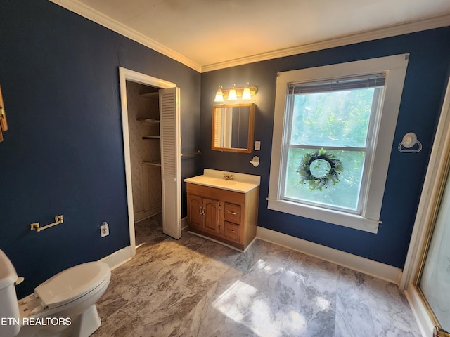 bathroom with crown molding, vanity, and toilet