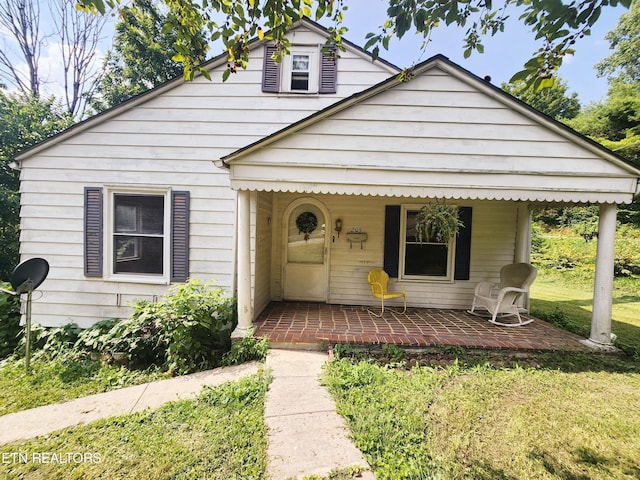 bungalow-style house featuring a front yard and a porch