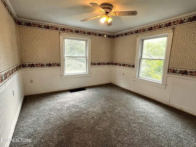 209 Greenwood Ave, Pennington Gap, VA 24277 - unfurnished room with wallpapered walls, wainscoting, healthy amount of natural light, carpet, and ceiling fan