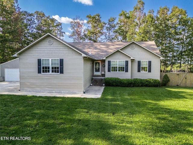 ranch-style home with an outbuilding, a garage, and a front yard