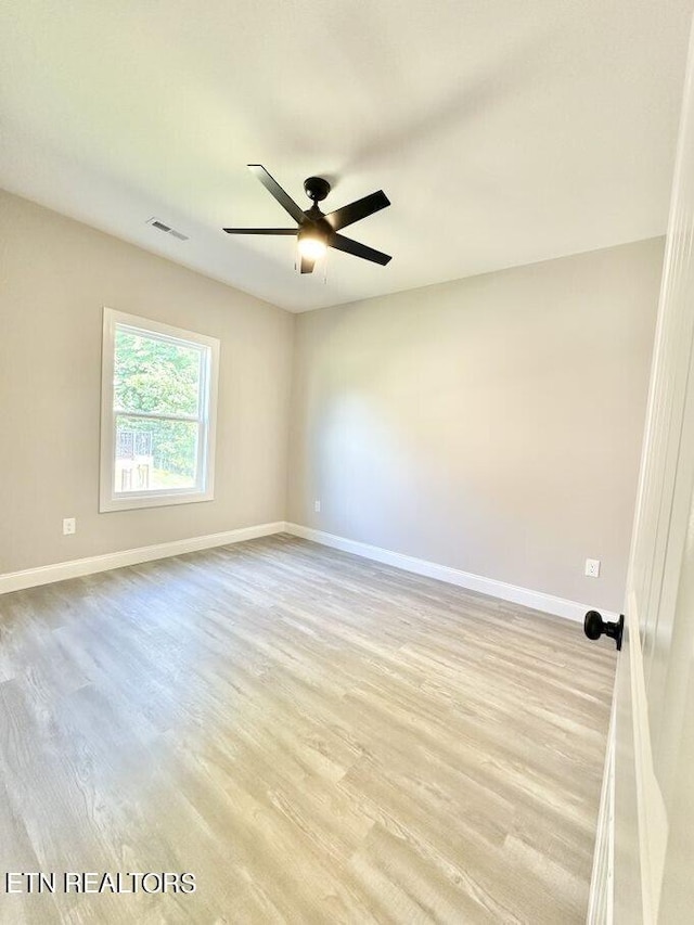 empty room featuring light hardwood / wood-style flooring and ceiling fan