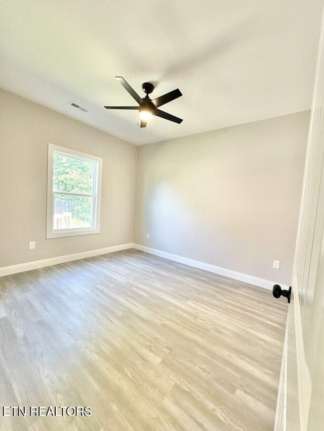 empty room featuring ceiling fan and light hardwood / wood-style floors