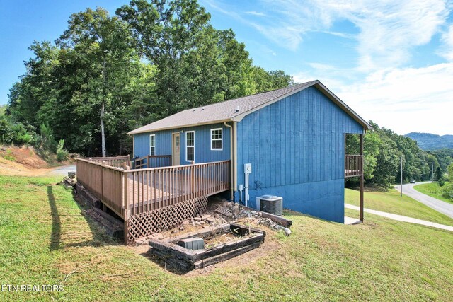 back of house featuring a yard, a deck, and cooling unit