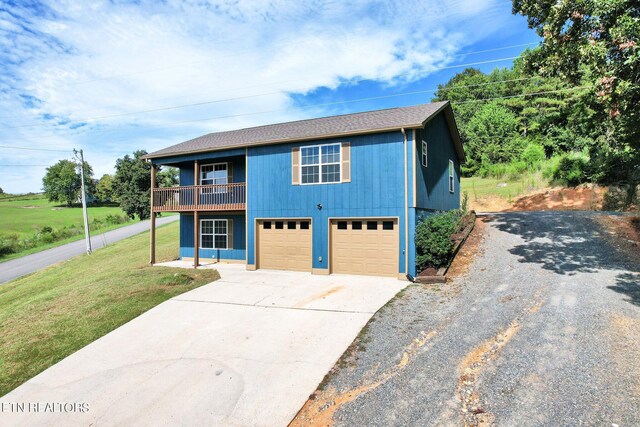 front facade featuring a garage and a front lawn