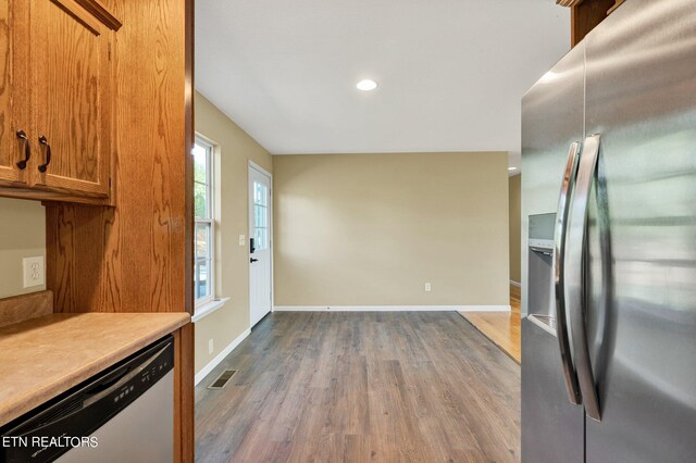 kitchen with hardwood / wood-style floors and stainless steel appliances