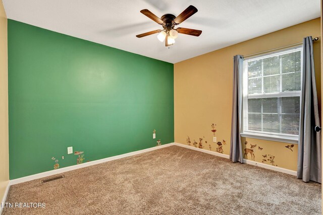 unfurnished room featuring light colored carpet and ceiling fan