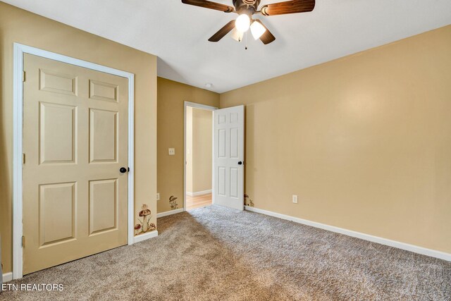 unfurnished bedroom with ceiling fan and light carpet