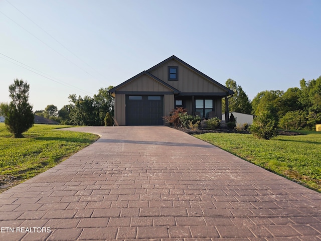 view of front of house with a garage and a front lawn