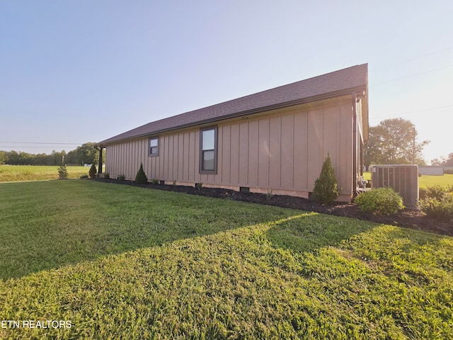 view of home's exterior featuring cooling unit and a lawn