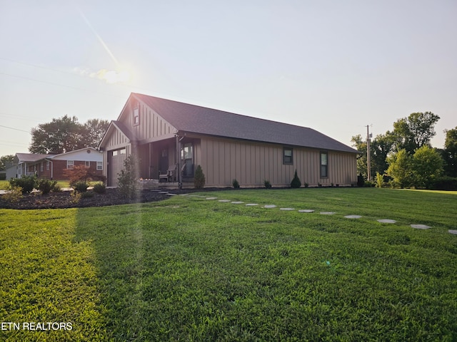 view of side of home with a lawn