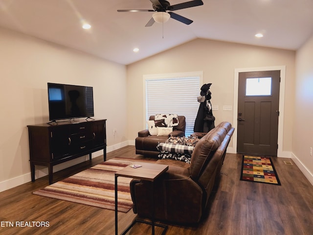 living room featuring wood-type flooring, ceiling fan, and vaulted ceiling