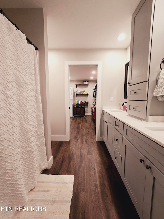 bathroom featuring dual vanity and wood-type flooring