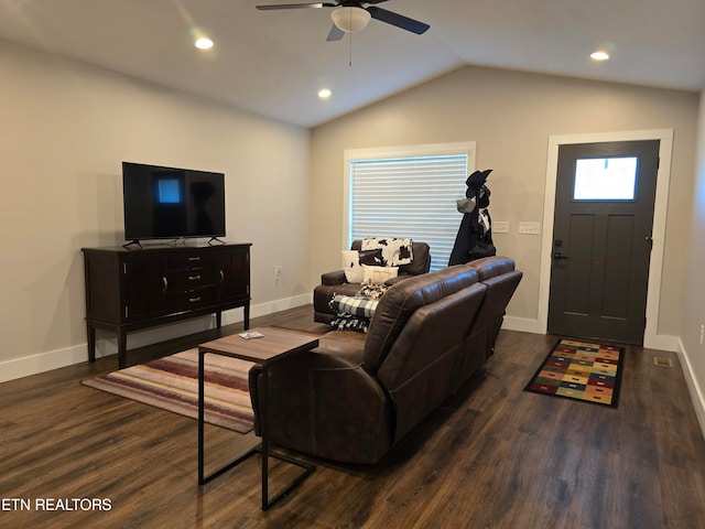 living room featuring ceiling fan, vaulted ceiling, and dark wood-type flooring