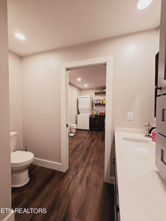 bathroom with vanity, toilet, washer / clothes dryer, and wood-type flooring