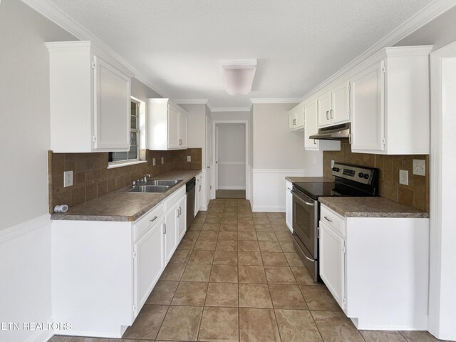 kitchen featuring tasteful backsplash, stainless steel appliances, light tile patterned floors, and white cabinets