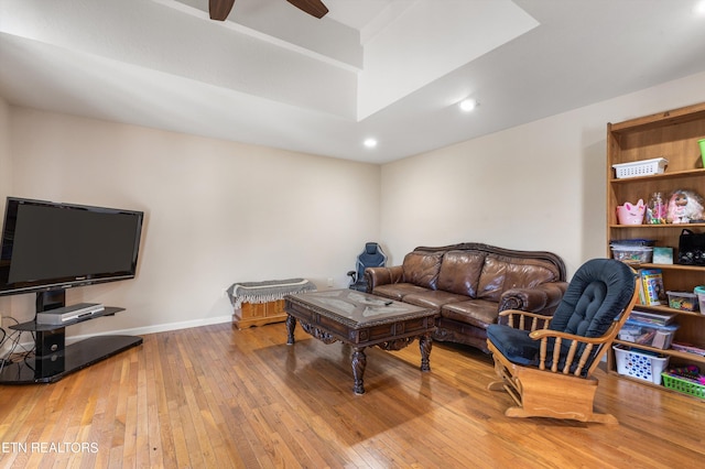 living room with ceiling fan and light hardwood / wood-style floors