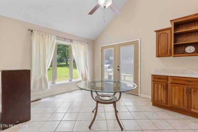 dining room featuring ceiling fan, light tile patterned floors, french doors, and high vaulted ceiling