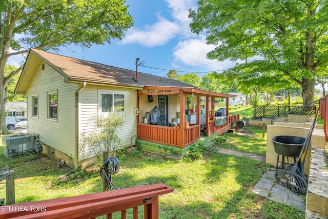 exterior space featuring a yard, cooling unit, and fence