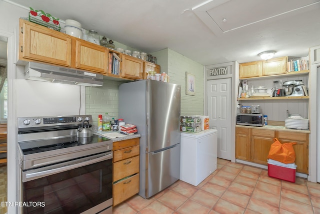 kitchen featuring stainless steel appliances, tasteful backsplash, light countertops, light tile patterned flooring, and under cabinet range hood