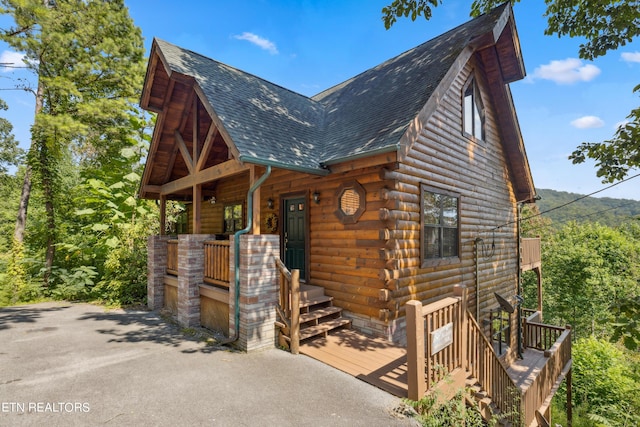 log cabin with a porch