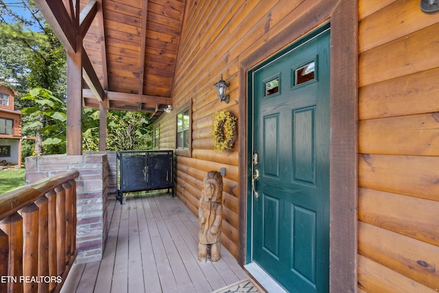 view of exterior entry with covered porch