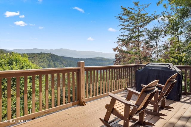 deck featuring a mountain view and a grill