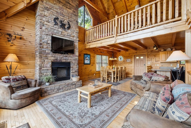 living room featuring a healthy amount of sunlight, wooden ceiling, and wooden walls