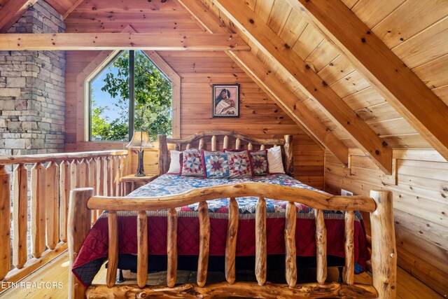 bedroom with lofted ceiling with beams, wooden walls, wood-type flooring, and wooden ceiling